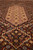 Low angle detail showing silk sheen in the pale medallion and dense hand-knotted wool pile