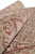 Rolled section highlighting silk sheen across rust, cream and garnet floral border motifs