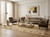 Neutral living room styled with golden beige hand knotted wool rug under glass coffee table