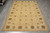 6'1 x 9' Chobi Peshawar rug laid flat on grey tile showing the full design