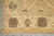 Corner of the beige border with large brown rosette, fleur palmette and ivory fringe