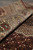Rolled edge showing thick wool and silk pile, palmette border and red selvage