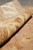 Rolled edge of the 6 x 9 wool rug showing pile depth and ivory border