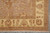 Corner detail with ivory border, brown vine and shield cartouches beside the tan floral field