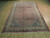 Hand-knotted wool Bijar rug viewed lengthwise, coral field and ivory paisley border visible
