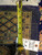 5 x 8 hand-woven tag and tape measure resting on the tightly knotted cotton foundation