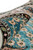 Rolled edge detail revealing lustrous silk pile sheen across turquoise field and pink flower heads