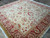 Angled view showing scrolling vines, palmettes and deep red border of this new Ziegler design rug