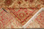 Folded corner revealing hand-knotted back, tight knot count and cotton foundation with ivory fringe tassels