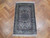 3' x 5' silk rug lying on herringbone parquet floor showing ivory field and medallion