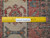 Reverse side with ruler proving authentic handmade knots per square inch of this Persian Hamedan rug