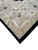 Corner detail of the sand ivory border, black outer band and ivory cotton fringe