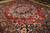 10x13 Persian Bakhtiar rug photographed at an angle, dense wool pile and navy cornerpieces visible