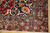 Corner detail showing rust brown border, blue rosettes, ivory guard stripes and original hand-knotted wool fringe