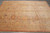 Large 10x14 Oriental rug laid flat, warm autumn palette of tan, saffron, rust and pink