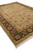 Corner angle of 10' x 14' wool area rug with ivory fringe and black border
