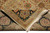 Folded back of hand-knotted rug showing tight weave, cotton foundation and hand-tied ivory fringe