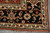 Corner detail of ivory leaf guard border, light blue outer stripe and red wool selvedge