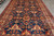 Overhead detail of all over floral lattice with palmettes and rosettes across the blue ground