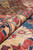 Rolled edge close-up showing plush Ghazni silky wool pile depth and tight hand-knotted weave