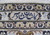 Woven weaver signature cartouche in navy script on the ivory border of this Kashan