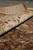 Rolled edge view of the ivory border showing silky sheen and tight weave density