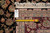 Reverse side with inventory tag and tape measure beside fine hand-knotted weave and cotton fringe