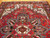 Close view of the stepped medallion, sky blue accents and ivory hooked vines on wool pile