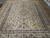 9'9" x 12'10" Kashan rug photographed from the opposite end on showroom tile floor