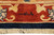 Woven signature cartouche in the rust inner border of this signed hand-knotted Chobi rug
