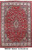 Deep red Persian Mahal rug with ivory floral border and small ivory central medallion, overhead view