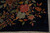 Macro view of pink rose, celadon green blossom and maple leaves on navy wool