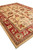 Corner perspective of hand-knotted wool room size rug, beige ground and coral floral border