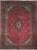 Red Persian Kashan rug with navy lobed medallion, ivory corner spandrels and dense floral field
