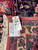 Reverse side and dealer tag confirming hand-woven construction, rug number F-6987 and 1980s Persian weaving