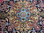 Ivory and sand central medallion with sky blue star rosette on navy hand-knotted wool ground