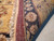 Folded back corner showing cotton foundation, hand-knotted wool pile and ivory fringe along the selvage