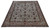 10'2" x 13' signed Tabriz rug photographed at an angle, ivory field with floral border