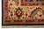 Corner detail of ivory border cartouche with red rosette, sage leaves and knotted cotton fringe