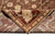 Folded corner revealing dense wool pile and tight hand-knotted back of this brown Oriental rug