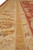 Low angle along the borders showing saffron gold guard band and ivory rosette stripe