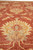 Floor level view across the coral red field with large ivory and gold palmettes