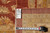 Reverse side with dealer tag reading 8'10 x 11'6 beside a tape measure for scale