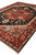 Three quarter view of dark blue Heriz Serapi rug, 9' x 12', with rust medallion centerpiece