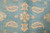 Detail of 8 petal rosette and paisley motifs woven in cream on aqua blue