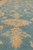 Low angle view of soft gold and ivory palmette on aqua blue wool field