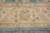 Ivory main border close-up with gold palmette, pastel florals and aqua blue outer band