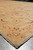 Close corner view of selvage, apricot inner stripe and small rosette motifs in wool pile
