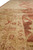 8'10" x 11'7" Oriental rug border seen at an angle, sand gold ground with rust vines