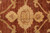 Macro detail of gold rosettes and small cartouche motif woven into deep rust field